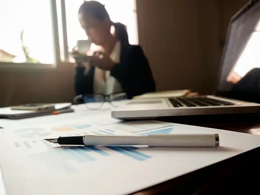 business-concept-with-copy-space-office-desk-table-with-pen-focus-analysis-chart-computer-notebook-cup-coffee-desk-vintage-tone-retro-filter-selective-focus